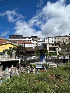 a group of white buildings in a city at Figueira River House in Bragança