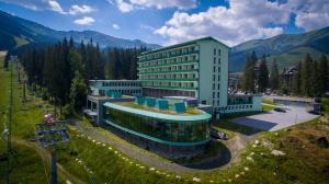 an aerial view of a building in the mountains at Hotel SOREA SNP in Belá