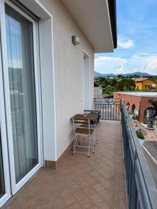 a balcony with a table and chairs on it at Bed And Breakfast Castello7 in San Felice del Benaco
