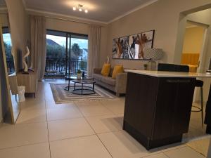 a living room with a couch and a table at Classy and Cosy 5 in Fourways