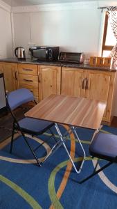 a wooden table and two chairs in a kitchen at Wanderlust Bergville in Bergville