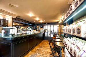 a restaurant with a bar and some tables and chairs at Montefiore 16 - Urban Boutique Hotel in Tel Aviv