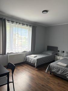 a bedroom with two beds and a window at Horiza in Gdańsk +15 photos