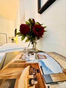 a vase of red roses sitting on a glass table at White Oak Loft in Schottwien +50 photos