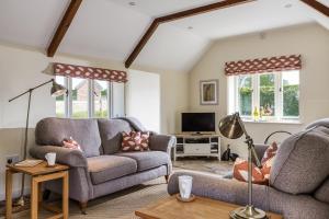 a living room with two couches and a tv at Downclose Piggeries in North Perrott