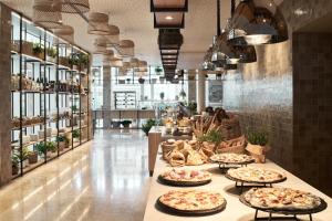 a store with several pizzas on display in a hallway at Falkensteiner Hotel & Spa Jesolo in Lido di Jesolo