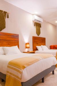 a hotel room with two beds and a heater at Collection O Kaab Downtown Tulum in Tulum +117 photos