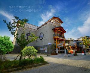 a building with a clock on the side of it at Hwangsil Tourist Hotel Seojoong in Jeonju