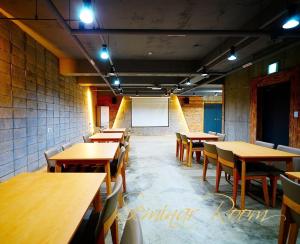 a restaurant with wooden tables and chairs and a whiteboard at Hwangsil Tourist Hotel Seojoong in Jeonju