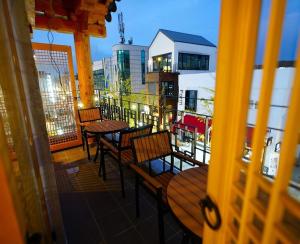 a balcony with tables and chairs on a building at Hwangsil Tourist Hotel Seojoong in Jeonju +8 photos