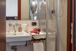 a bathroom with a sink and a shower at Hotel Resort La Rosa Dei Venti in Portopalo +57 photos