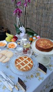 a table with pies and other food on it at La CASA DI OLIVER in Pian Camuno