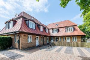a large brick house with a red roof at Haus Maybachstraße in Westerland
