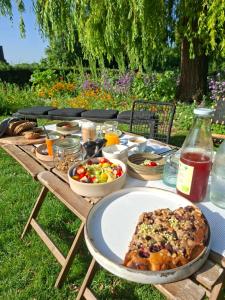 a picnic table with food and salad on it at K's Torentje in Kruishoutem