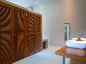 a bathroom with a sink and a toilet and a mirror at 3Br Villa Yin Kuo Private Pool Walk to Beach in Mae Nam +30 photos