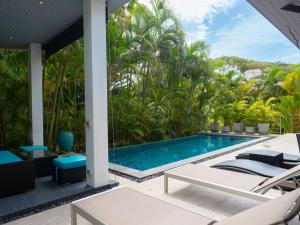 an outdoor swimming pool with a view of a resort at 3Br Villa Yin Kuo Private Pool Walk to Beach in Mae Nam