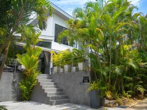 a building with stairs and palm trees in front of it at 3Br Villa Yin Kuo Private Pool Walk to Beach in Mae Nam