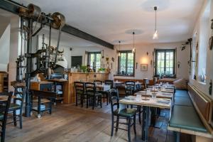 a restaurant with tables and chairs in a room at Hotel Oberschmied in Reit im Winkl