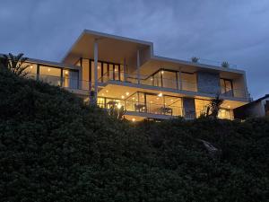 a large house on top of a hill at night at The Ocean View Guest House in Wilderness