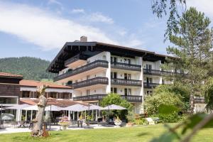 a large building with umbrellas in front of it at Bartl Apartments in Rottach-Egern