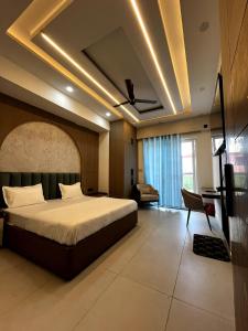 a bedroom with a bed and a ceiling with lights at Nagarkoti Residency Inn in Pithorāgarh