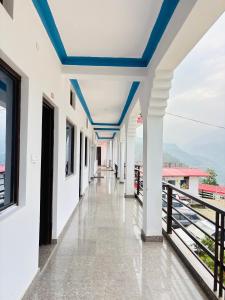 a corridor of a building with blue ceilings at R K Hotel & HELY ROOMS in Phata