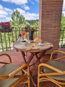 a wooden table and chairs on a patio at LA CANTERICA in Fuentes de Rubielos