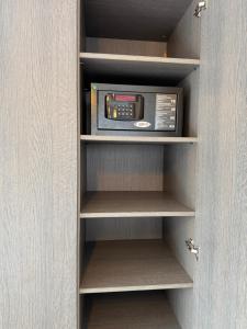 a microwave oven sitting inside of a closet at Malta Bodrum in Bodrum City