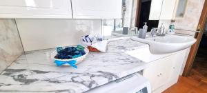 a white bathroom with a sink and a counter at Casa Colomba a Tirano in Tirano +32 photos