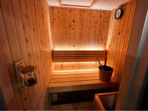 a small wooden sauna with a clock on the wall at Hotel Rose (Adult Only) in Gifu