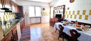 a kitchen with a table with a white table cloth at Casa Colomba a Tirano in Tirano