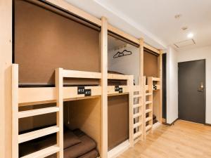 a hostel with bunk beds in a room at Akasaka Guesthouse HIVE in Tokyo