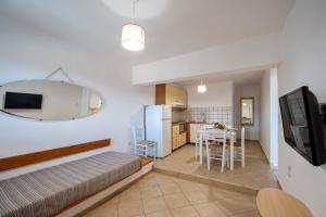 a living room with a bed and a kitchen at Niel Serifos in Serifos Chora