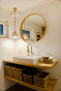 a bathroom with a sink and a mirror at Boutique Home Bad Iburg in Bad Iburg