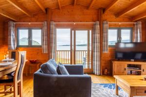 a living room with a couch and a table at Oakbank Farm in Lamlash