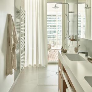 a bathroom with a sink and a large window at Falkensteiner Residences Jesolo in Lido di Jesolo +25 photos