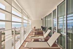 an apartment balcony with a view of the ocean at Falkensteiner Residences Jesolo in Lido di Jesolo