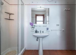 a white bathroom with a sink and a shower at Villa Fior di mare in Monte Nai +18 photos