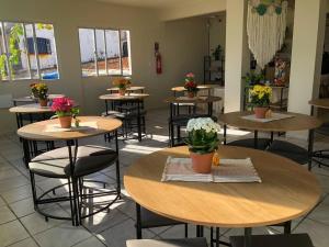 a restaurant with tables and chairs with flowers on them at Pousada Vilas do Frances Beira Mar in Praia do Frances +50 photos