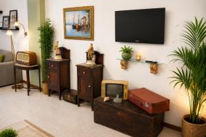 a living room with a tv on a wall at Flavia's House in Gaggi