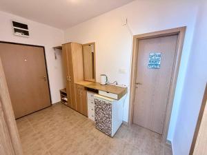 a small kitchen with a counter and a door at Sea Time Apartment in Budva +42 photos