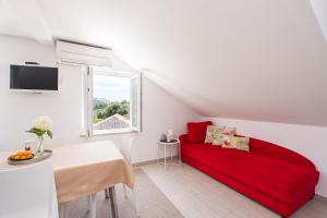 a living room with a red couch and a table at Hanas Dream Places in Zaton