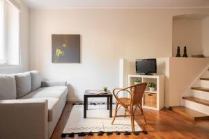 a living room with a couch and a table at Cadenabbia Lake side Apartments in Griante Cadenabbia