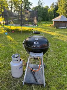 a bbq grill with a pan on top of it at ZenTen Apartment in Elva