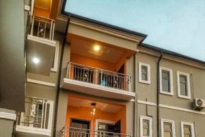 a building with balconies on the side of it at Apartment Sleeps 4 with Balcony and Parking in Asaba