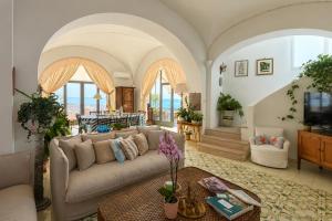 a living room with a couch and a table at Luxury Maison Cherie - Positano Charme & Sea View in Positano