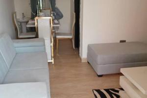 a living room with a couch and a table at Apartment Sleeps 4 with Balcony and Parking in Asaba +3 photos