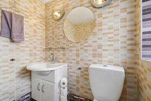 a bathroom with a toilet and a sink and a mirror at 4 Bedroom Central Birmingham in Birmingham +22 photos