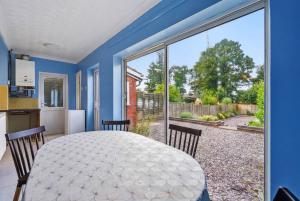 a kitchen and dining room with a table and a large window at 4 Bedroom Central Birmingham in Birmingham