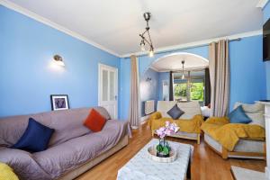 a living room with blue walls and a couch at 4 Bedroom Central Birmingham in Birmingham